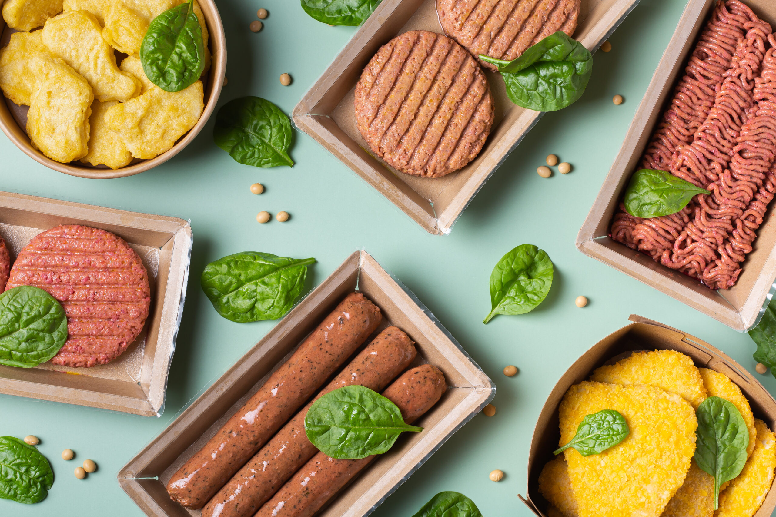 Assortment of plant based meat on a table. Food to reduce carbon footprint, sustainable consumption. View from above, flat lay food.