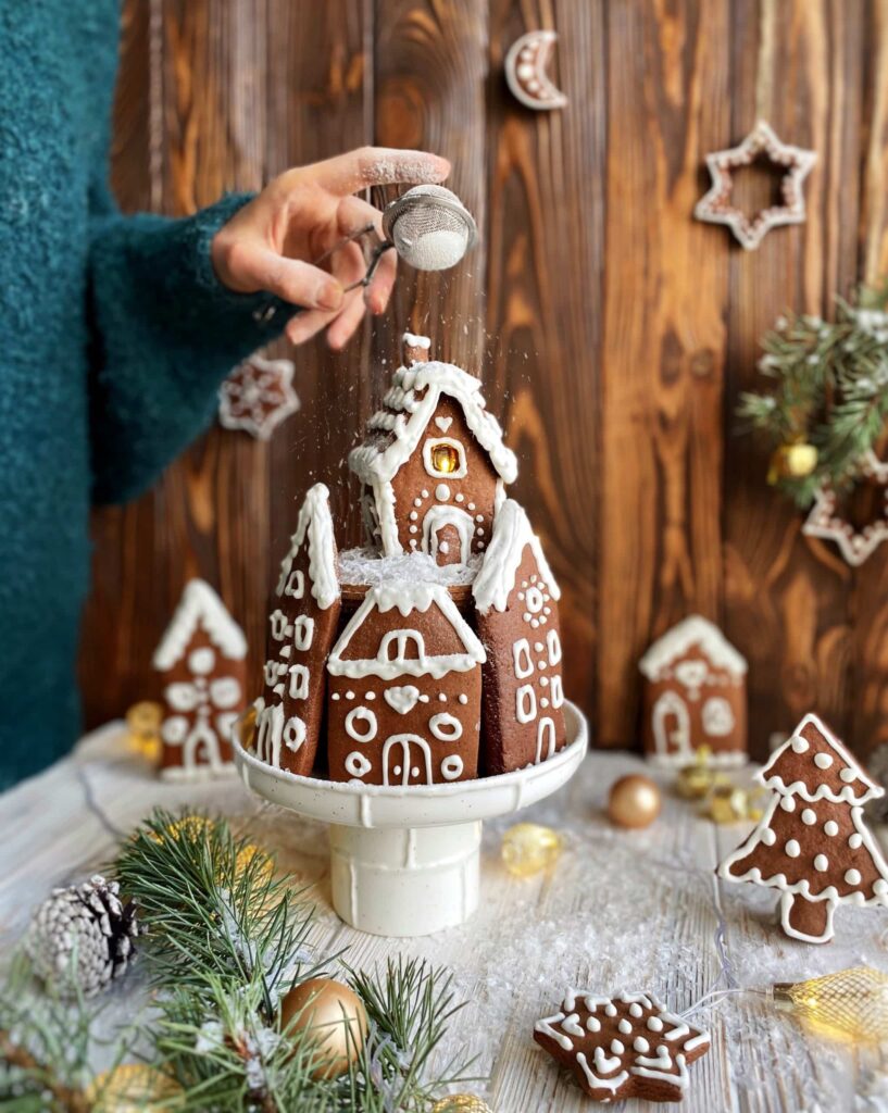 Sifting powdered sugar on a gingerbread house