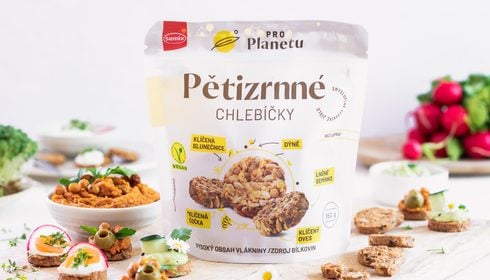 Sáček veganských vícezrnných krekrů značky Semix, obklopený malými krekrky s pomazánkami, zeleninou a bylinkami.