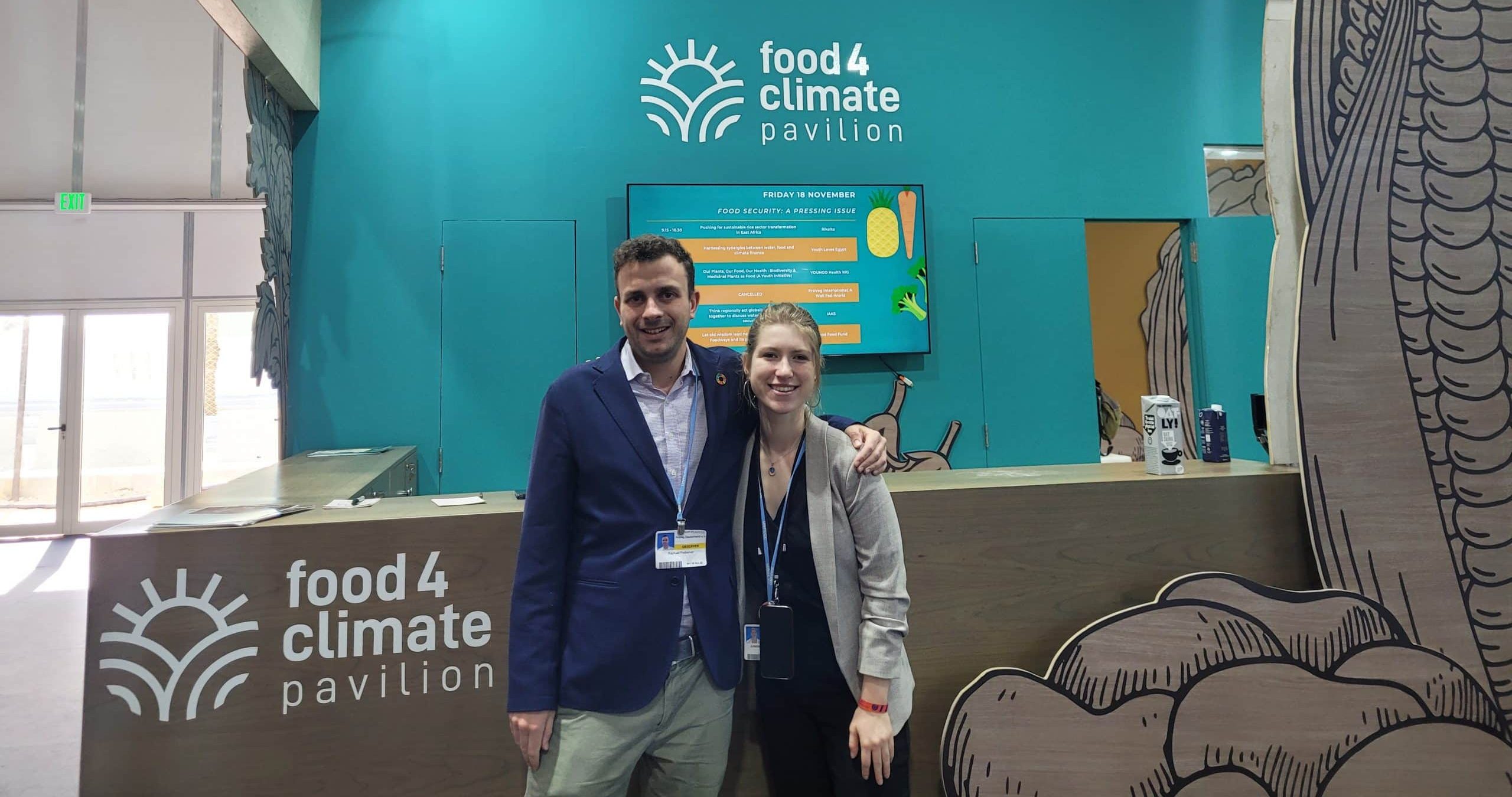 Raphael Podselver and Juliette Tronchon standing in front of the food4climate pavillion