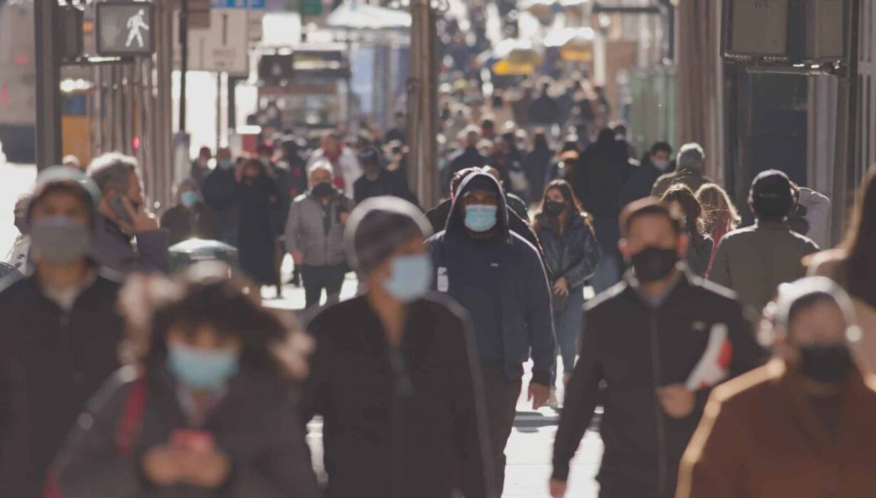 a crowd of people wearing masks